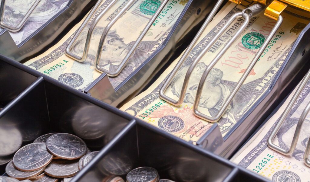 Open Cash Register Drawer Close up with Money.